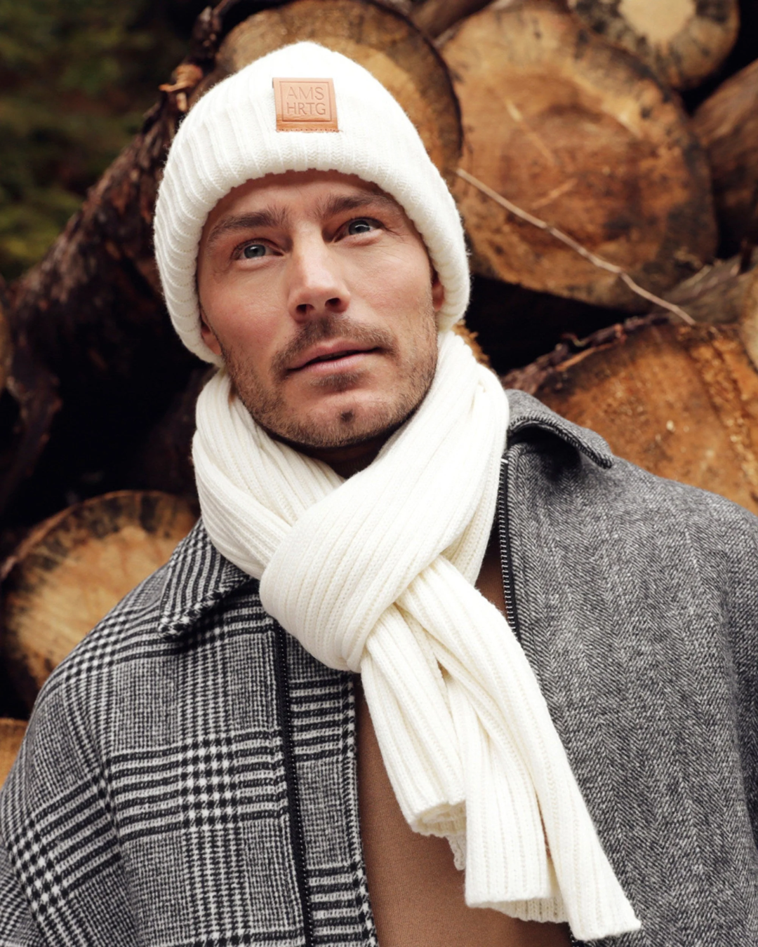Unisex Ribbed Knit Scarf - Ivory; shown on man in front of woodpile | Malvern Saddlery