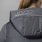 Schockemöhle Sports SPMalea Style Womens Vest - Gray aka Dusty Chocolate, detail back view on woman, of hood | Malvern Saddlery