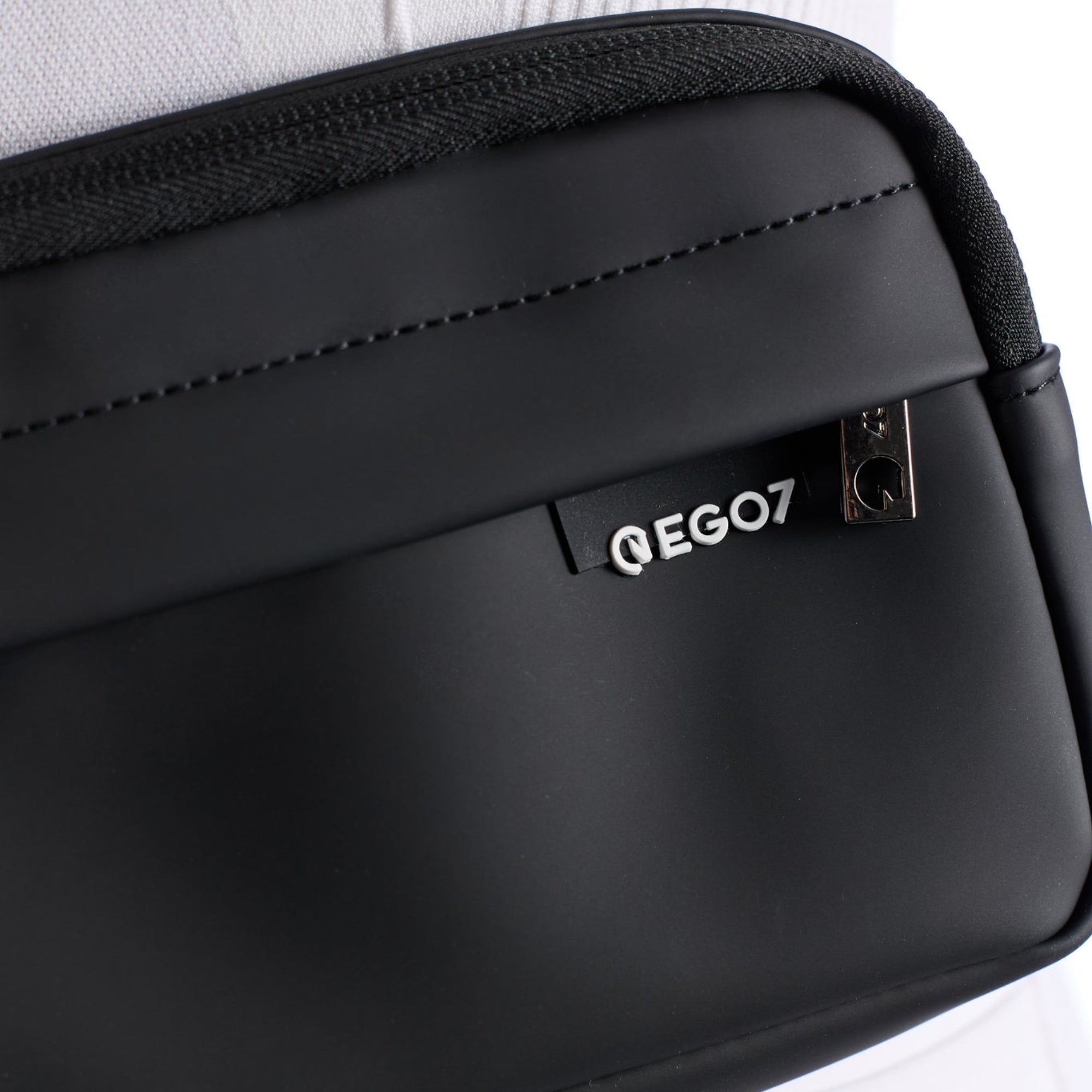Close-up of the waterproof soft-touch fabric and raised EGO7 logo detail on the black Agnes Pouch