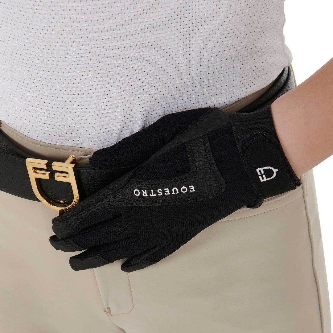 Equestro Young Rider Technical Gloves - Black; close up shown on model hands wearing riding apparel on white background | Children's Riding Accessories | Malvern Saddlery