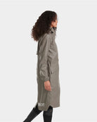 Horse Pilot Long Raintech Coat - Coffee brown - side view, worn by woman against white background | Women's Outerwear | Malvern Saddlery