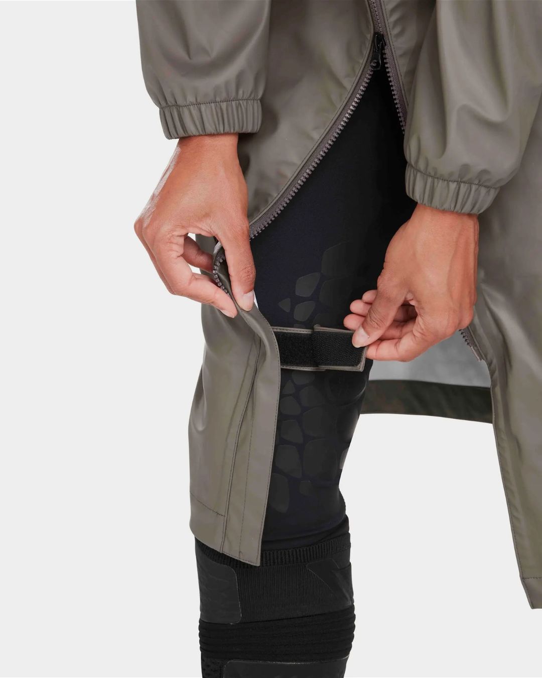 Horse Pilot Long Raintech Coat - Coffee brown - detail of thigh strap -worn by woman against white background | Women's Outerwear | Malvern Saddlery