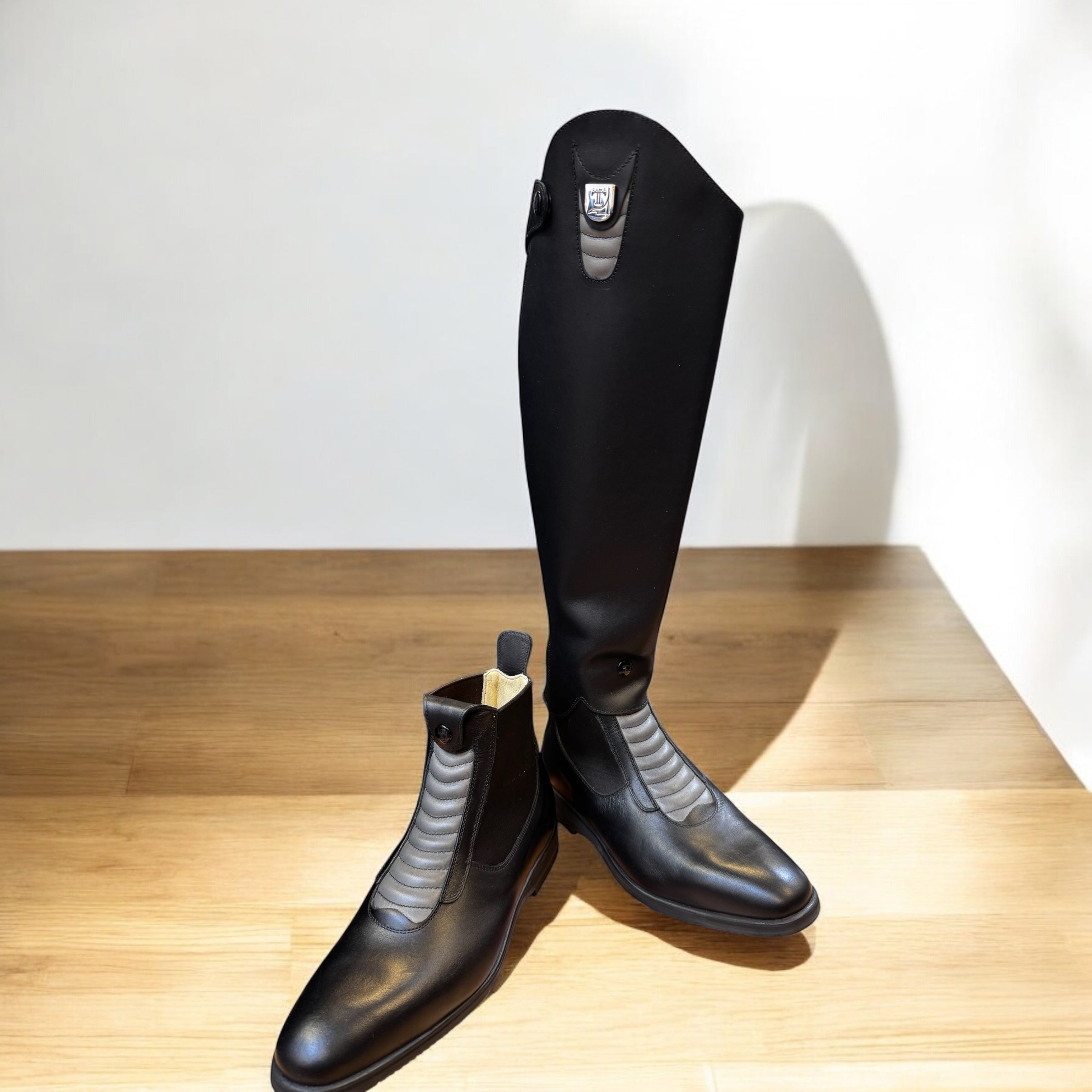 Tucci Harley Half Chap Black with Gray details, shown with matching paddock boots | Malvern Saddlery