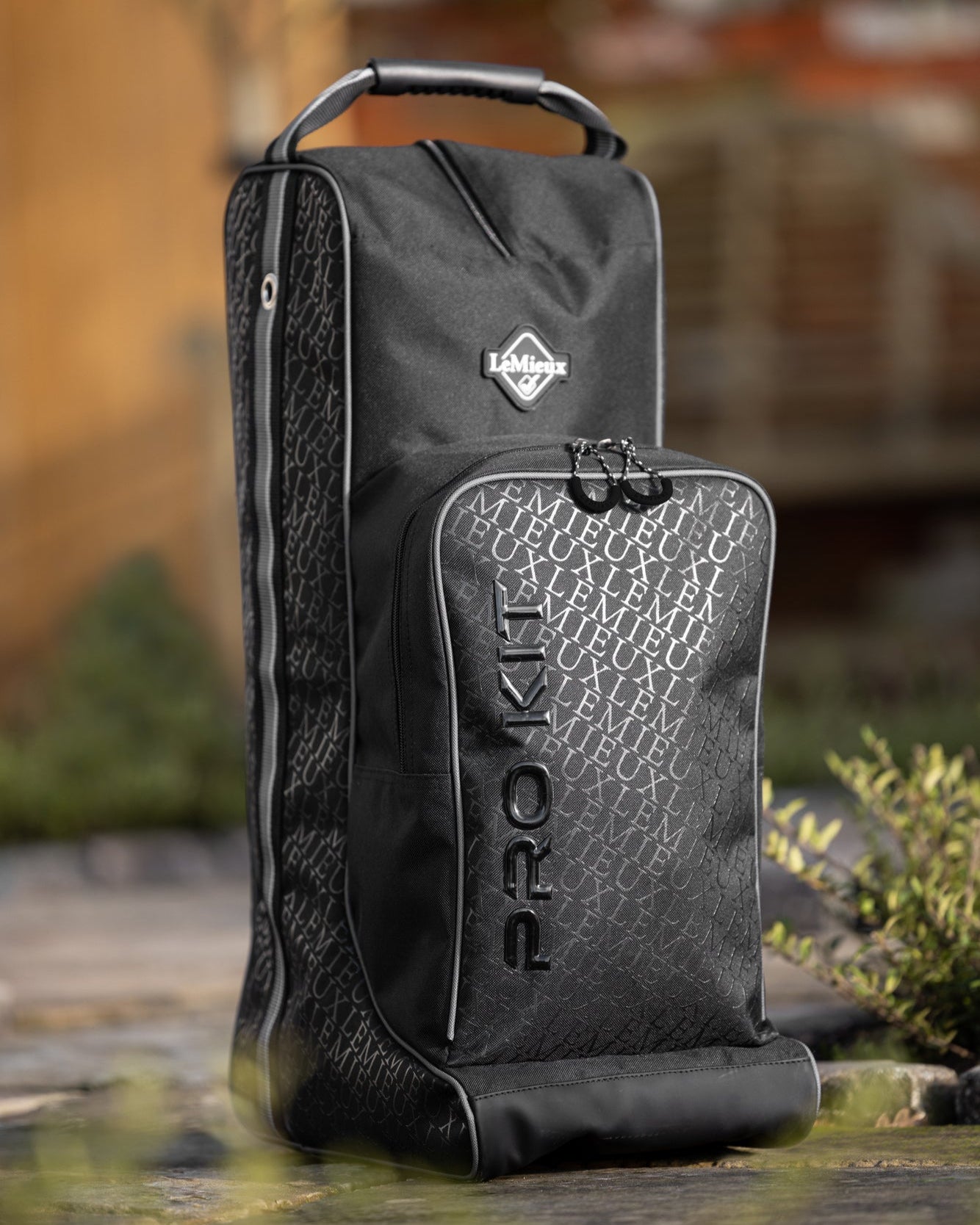 LeMieux Elite Pro Helmet & Boot Bag - Black, shown outdoors | Equestrian Accessories | Malvern Saddlery