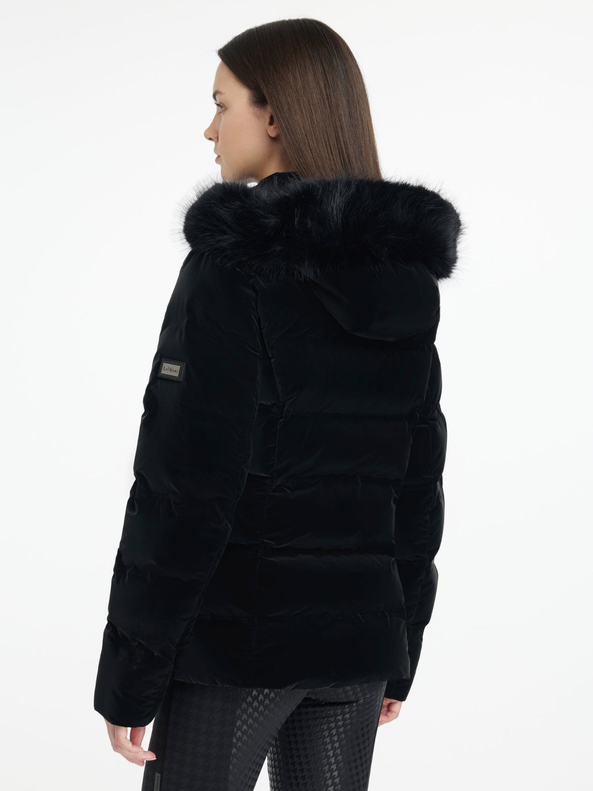 LeMieux Aspen Puffer Jacket - Black; back view shown on model wearing  | Ladies' Outerwear | Malvern Saddlery