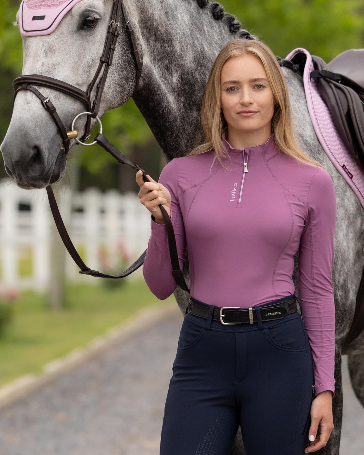LeMieux Classique Women's Base Layer Top - Mallow Pink - shown on woman standing next to horse outdoors | Malvern Saddlery