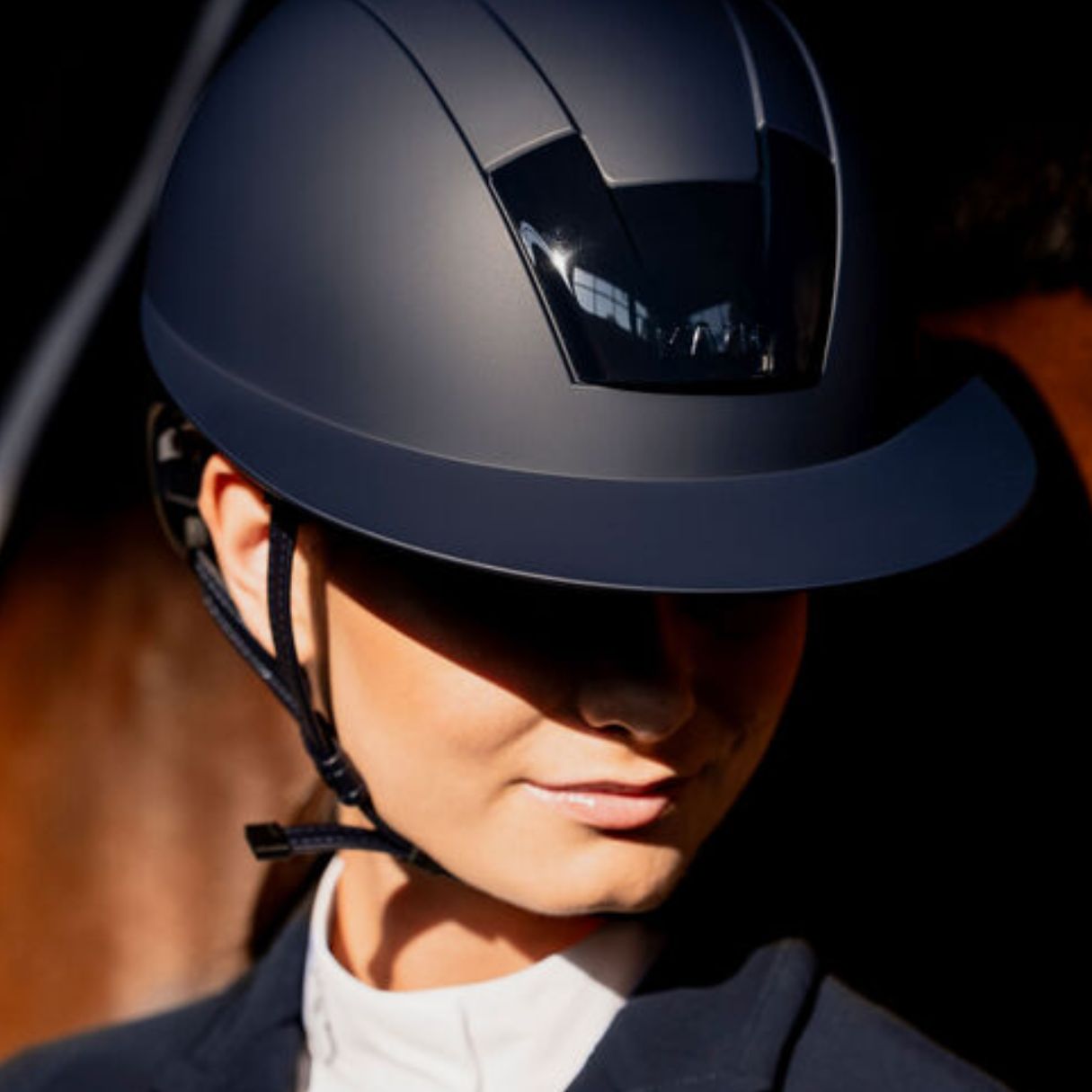 KASK Kooki Lady Equestrian Helmet - Navy Matte; lifestyle close up worn by woman | Wide Brim Helmets | Malvern Saddlery