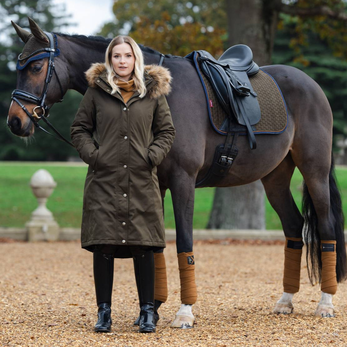 LeMieux Suede Dressage Square Saddle Pad - Alpine, lifestyle on horse with model in matching outerwear | Malvern Saddlery