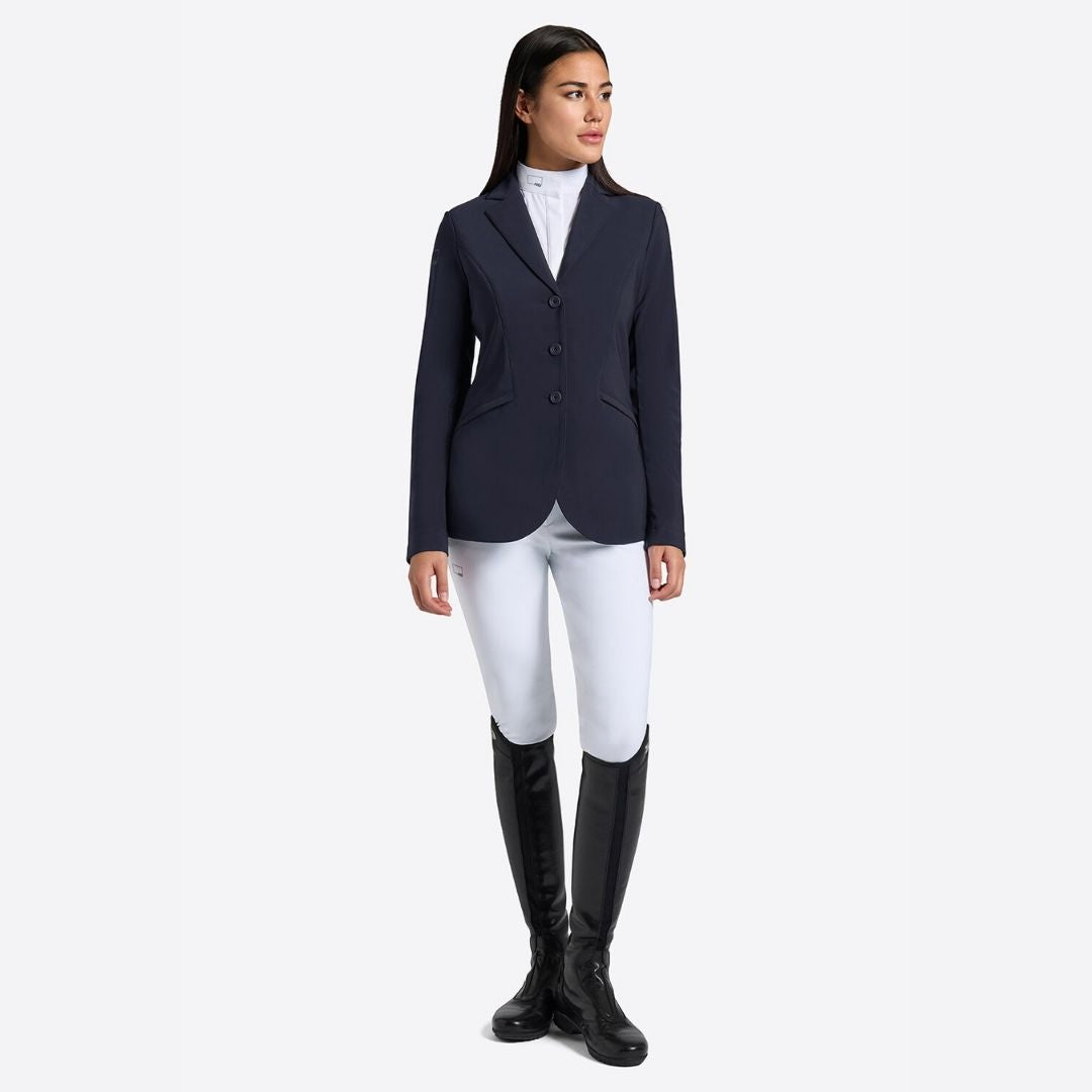 Rider's Gene Women's Jersey Competition Jacket - Navy; worn by woman wearing white breeches, black riding boots; shown on lt gray background | Women's Show Jackets | Malvern Saddlery