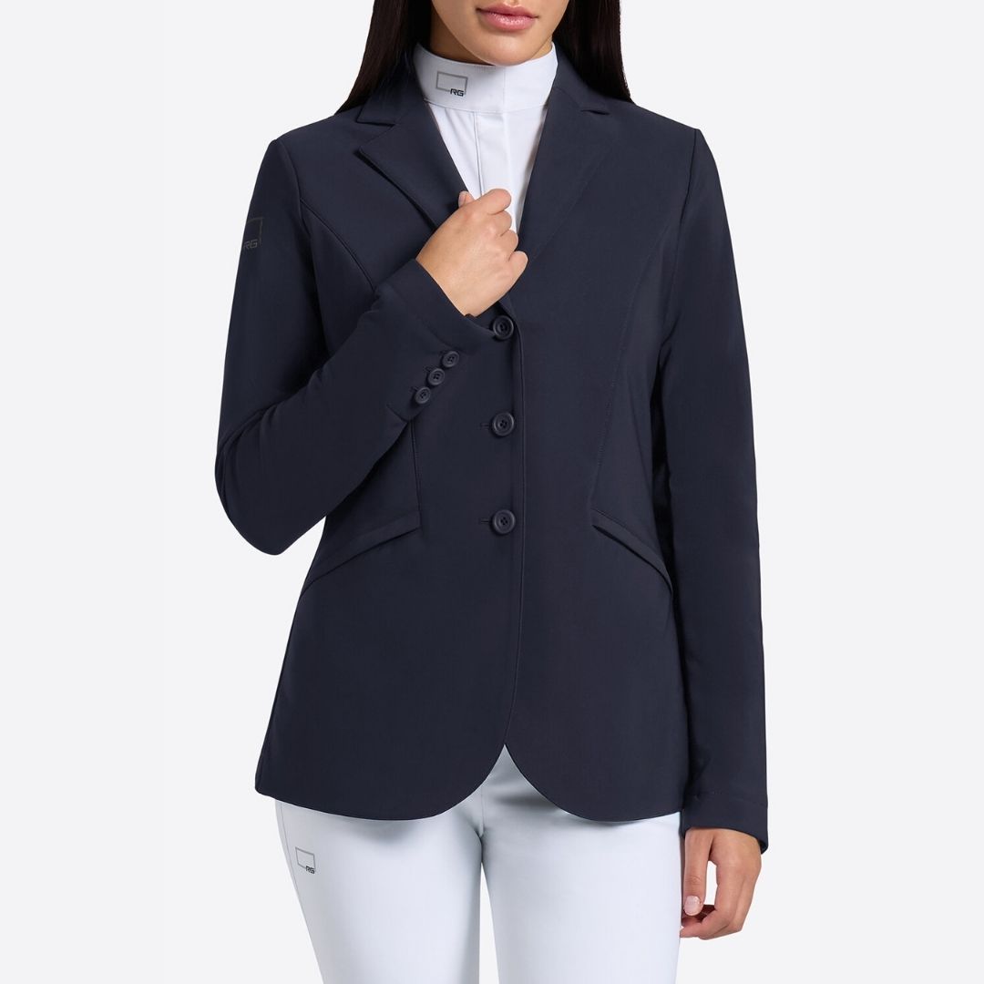 Rider's Gene Women's Jersey Competition Jacket - Navy; close up worn by woman wearing white breeches; shown on lt gray background | Women's Show Jackets | Malvern Saddlery