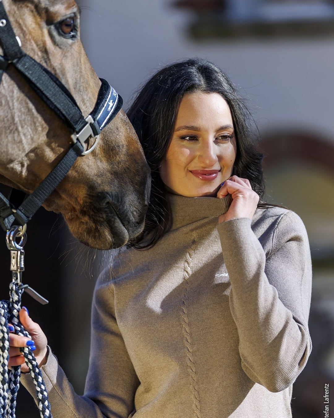 Schockemöhle Sports SP Josie Style Turtleneck Sweater - Hazel; shown on woman standing next to horse with blurred background | Ladies Sweaters | Malvern Saddlery