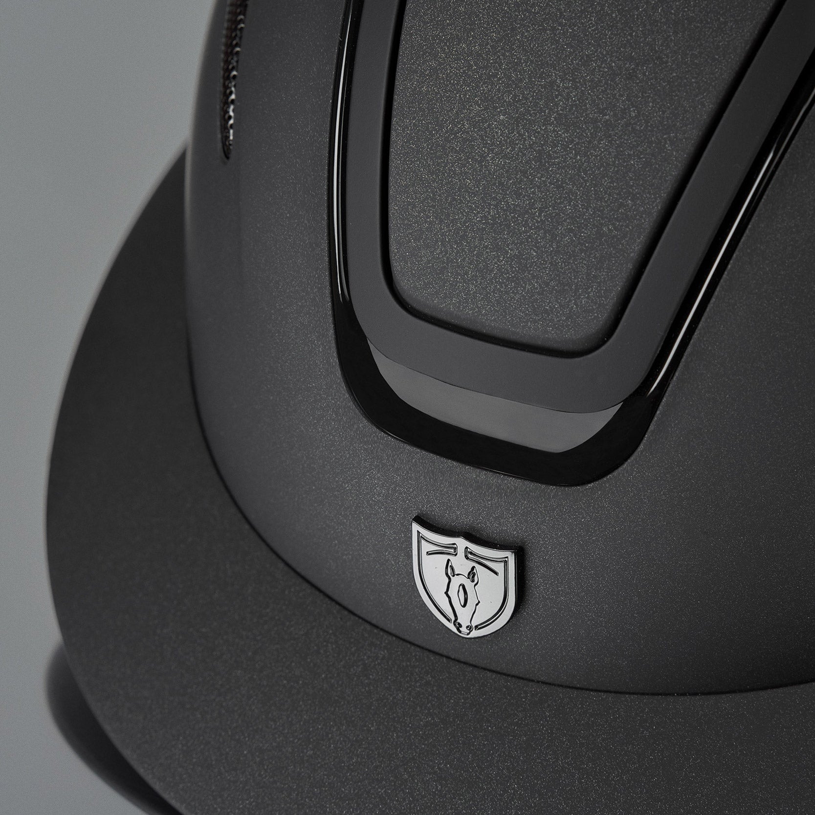 Tipperary Oxford Shimmer MIPS® Wide Brim Helmet - Black with Matte/Gloss trim; close up of brim, front trim gray background | Equestrian Helmets | Malvern Saddlery