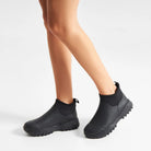 Woden Irene Waterproof Boot - Black shown on model from knees down on white background | Malvern Saddlery