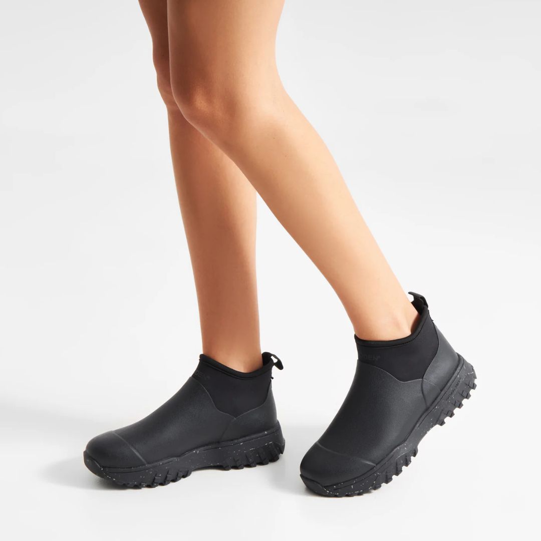 Woden Irene Waterproof Boot - Black shown on model from knees down on white background | Malvern Saddlery
