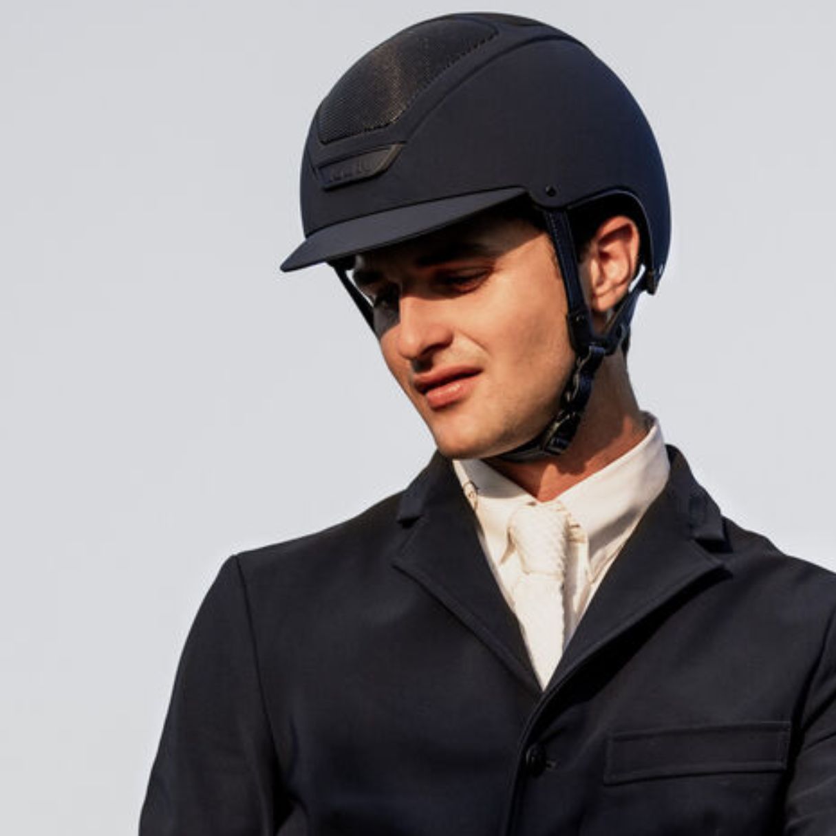 KASK Equestrian Dogma Hunter Helmet - Navy; shown on rider wearing show coat & tie | Malvern Saddlery