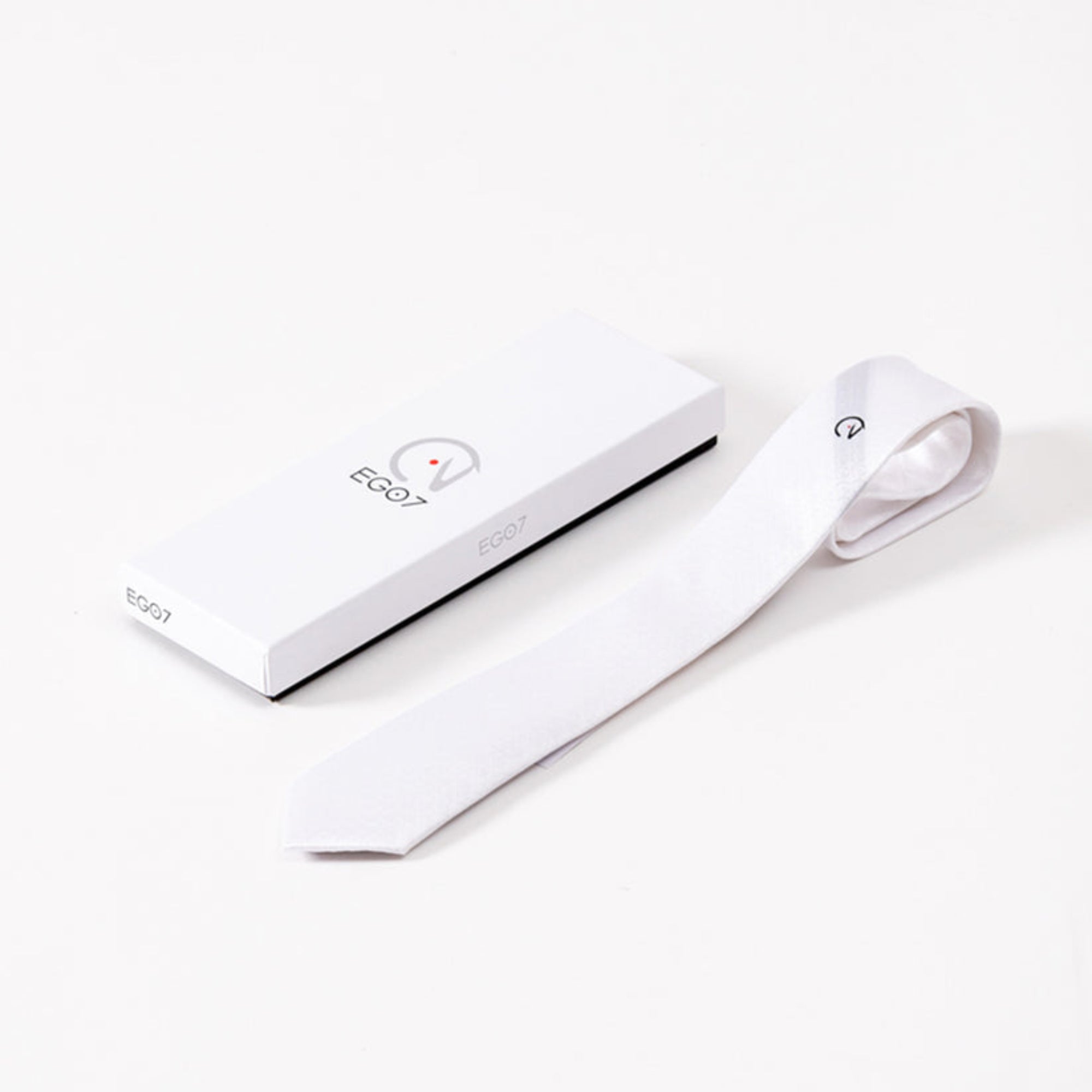 White EGO7 men's equestrian horse head show tie laid flat next to its branded white gift box.