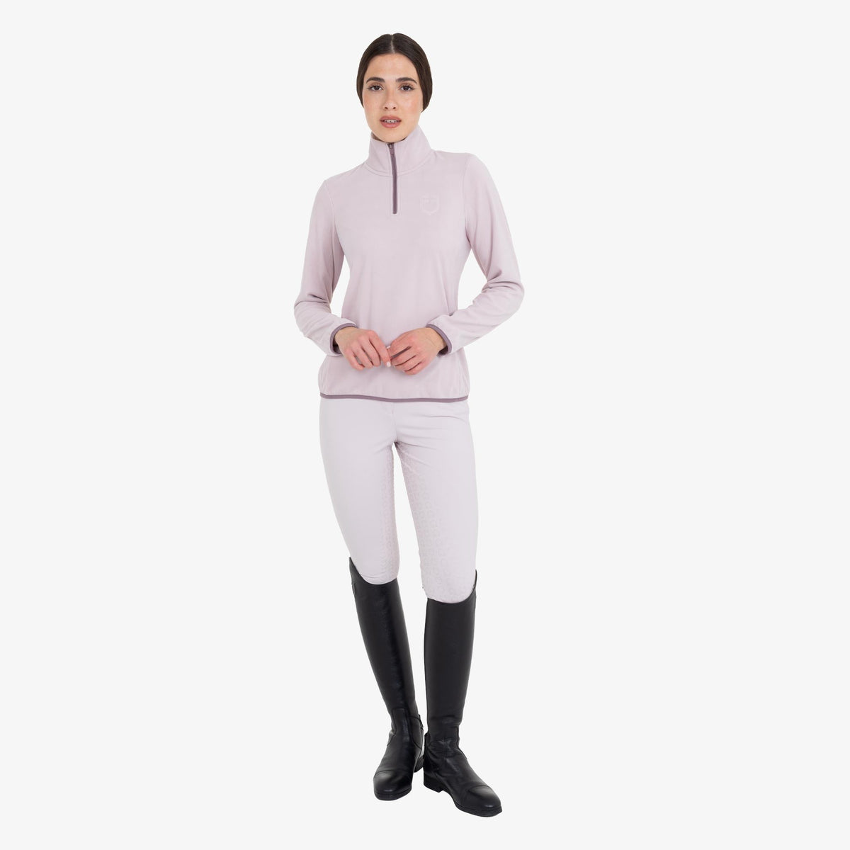 Equestro Women's High Neck Fleece 3/4 Zip Sweatshirt in Hushed Violet worn with breeches and tall boots