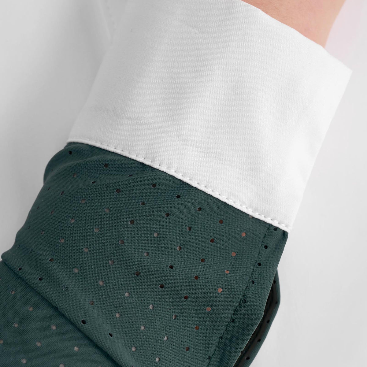 Equestro Girls' Long Sleeve Competition Polo in Pine Grove perforated sleeve and cotton cuff close up