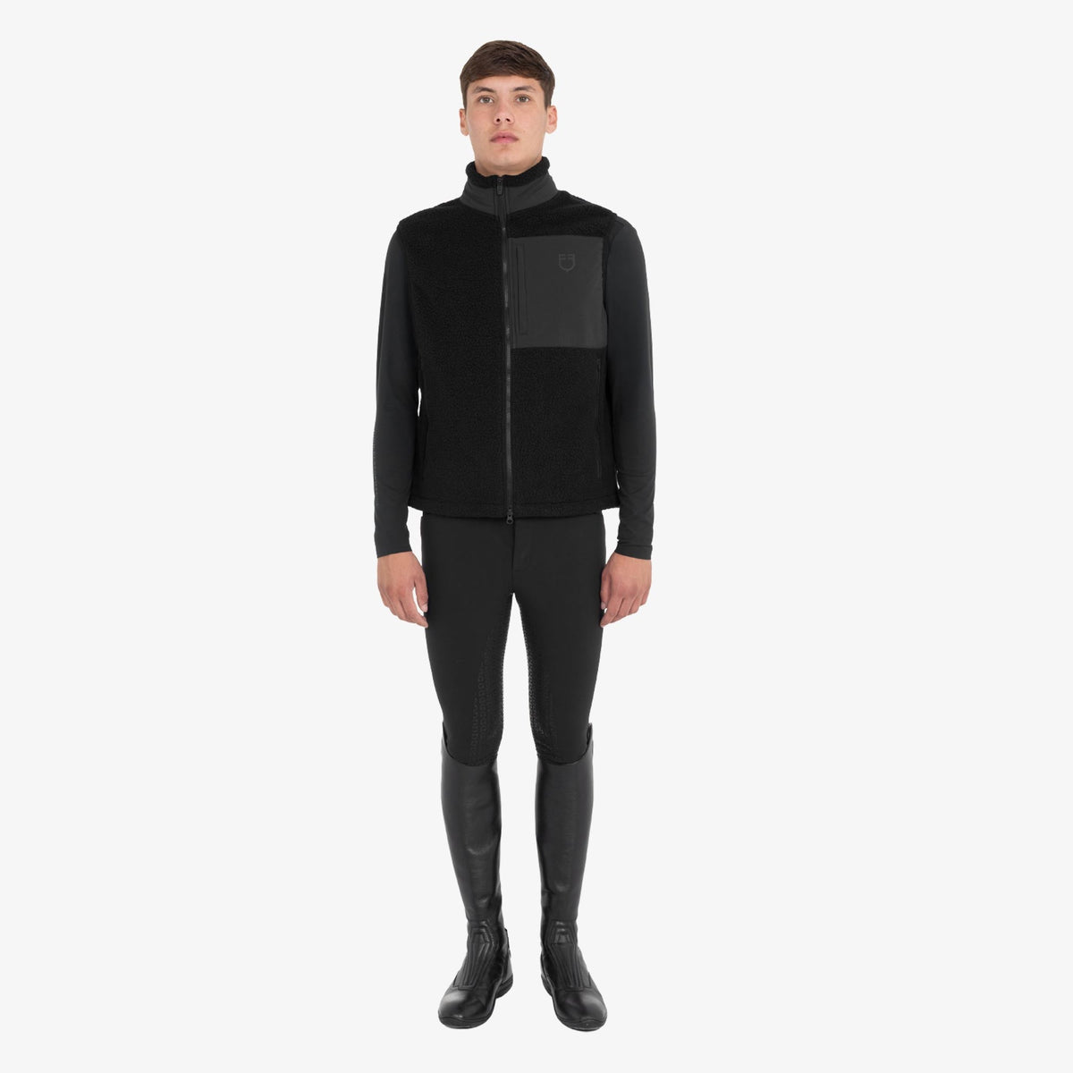 Equestro Men's Teddy Fleece Vest in Black worn with breeches and tall boots