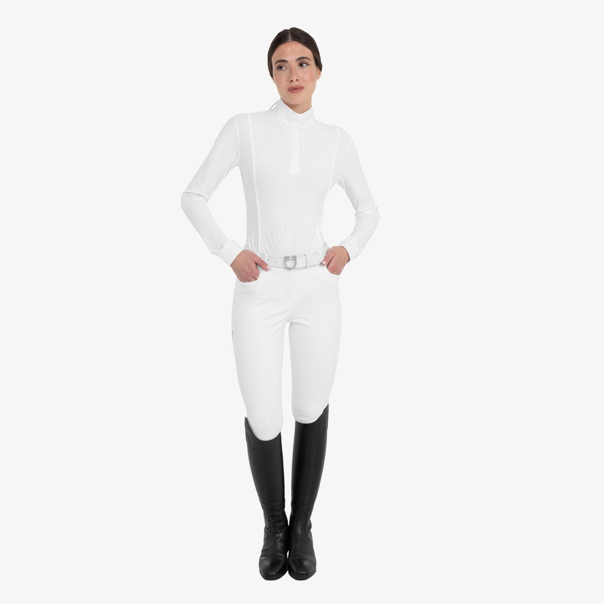 Equestro Women's Perforated Long Sleeve Competition Polo in White worn with breeches and tall boots