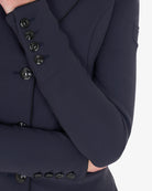 Equestro Women's Elegance Show Coat - Navy Blazer; sleeve button detail shown with arms in front | Equestrian Competition Apparel | Malvern Saddlery