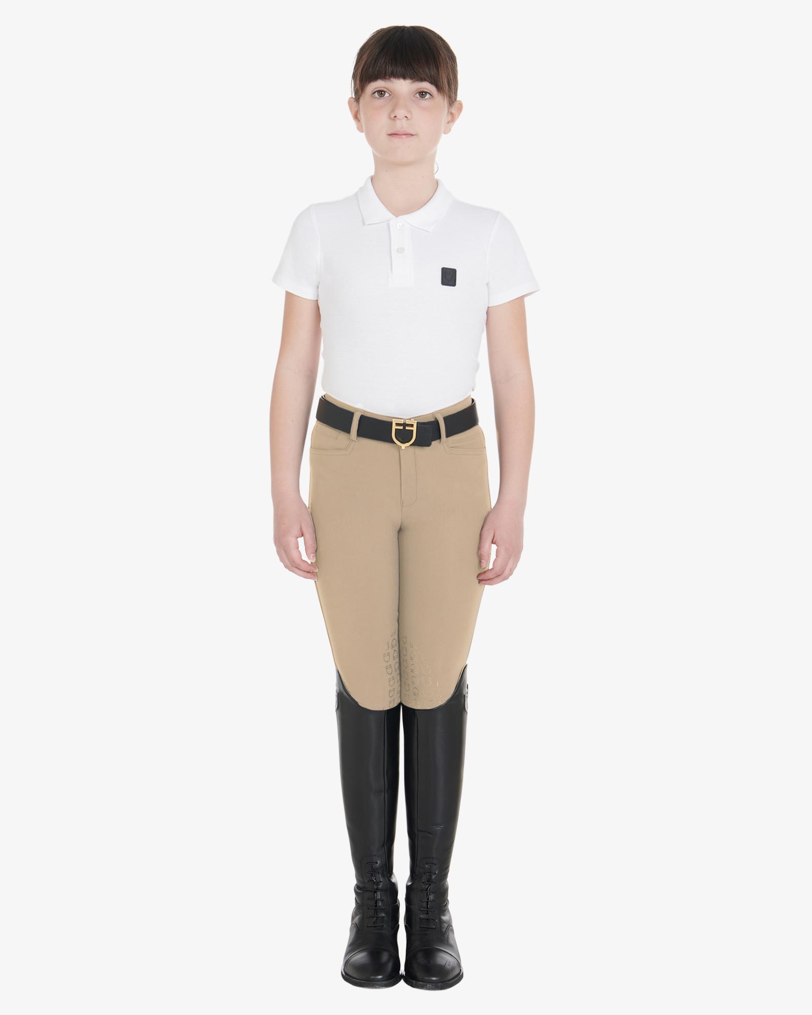 Equestro Girls Slim Fit Competition Breeches - Tan, shown on girl with belt, boots & shirt | Young Rider Apparel | Malvern Saddlery