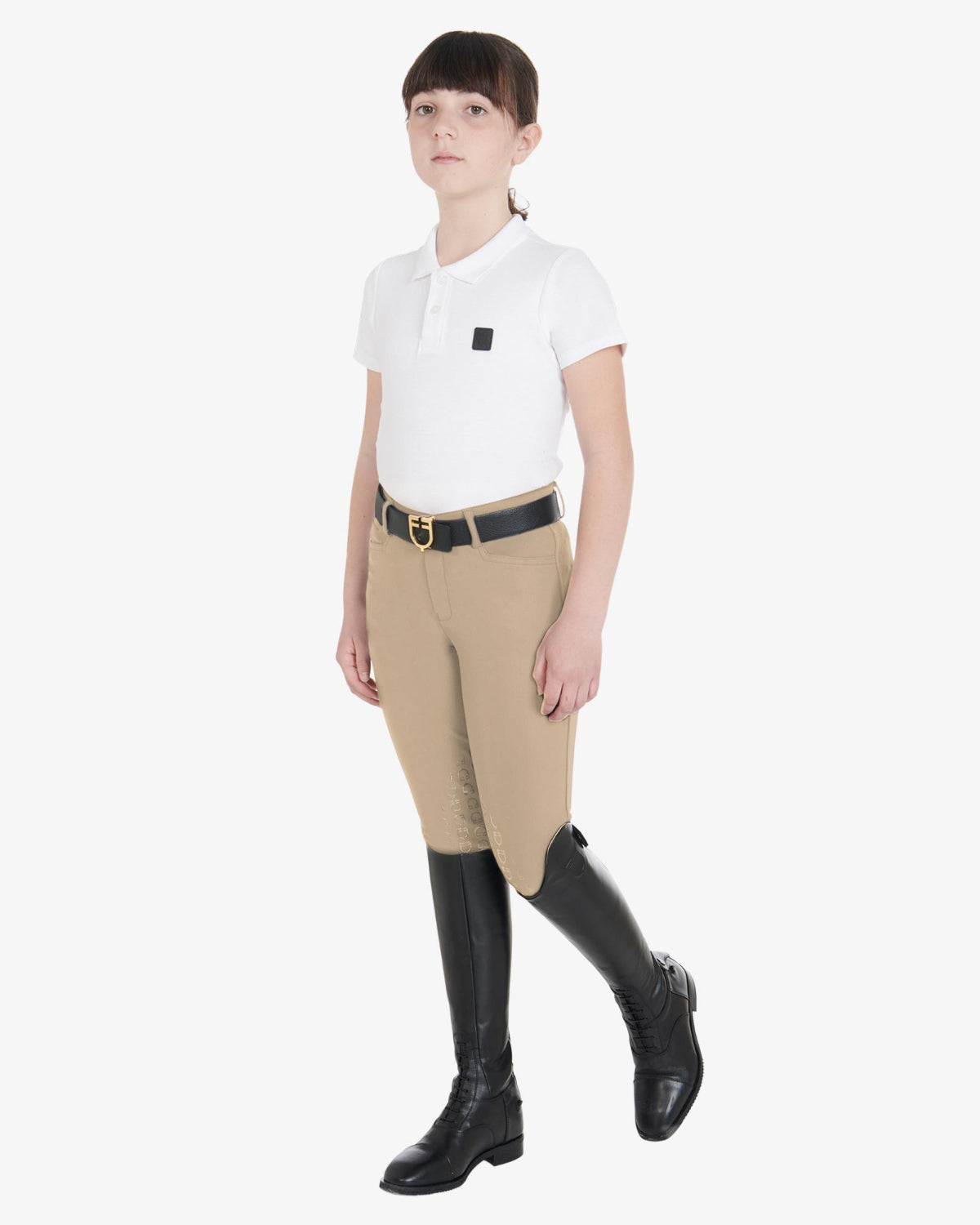 Equestro Girls Slim Fit Competition Breeches - Tan, shown on girl with belt, boots & shirt | Young Rider Apparel | Malvern Saddlery