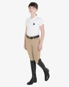 Equestro Girls Slim Fit Competition Breeches - Tan, shown on girl with belt, boots & shirt | Young Rider Apparel | Malvern Saddlery