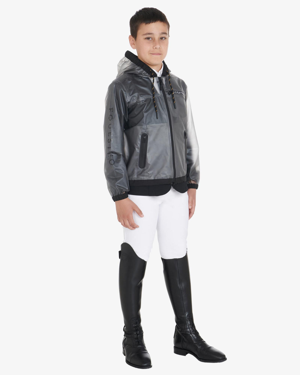 Equestro Young Rider Unisex Raincoat - shown on boy wearing show coat under, white breeches & black riding boots  | Children's Riding Apparel | Malvern Saddlery