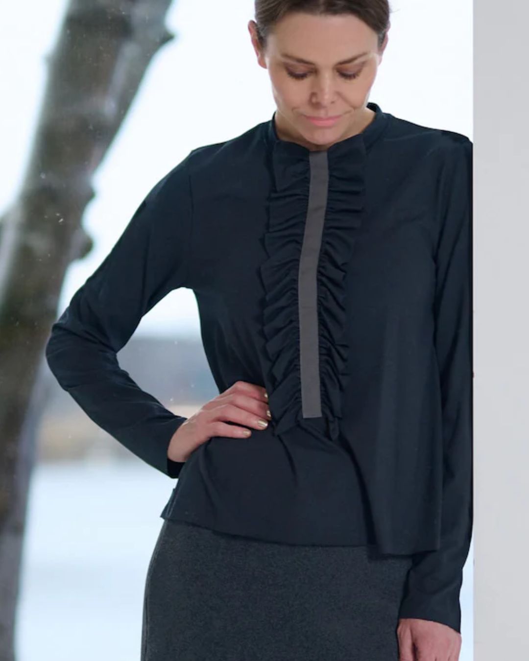 Henriette Steffensen Frill Blouse - Black; shown on woman against blurred background | Malvern Saddlery