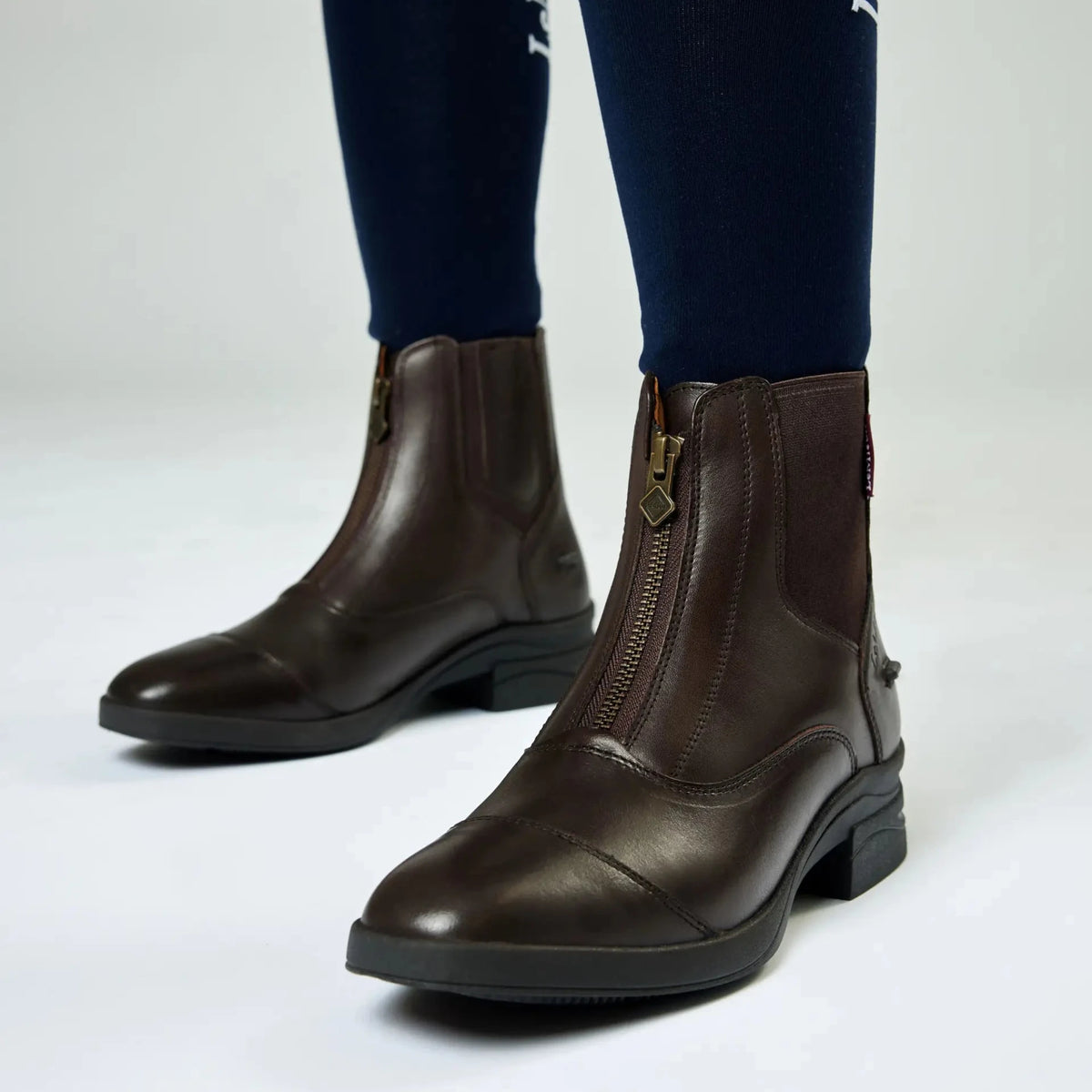 LeMieux Junior Zip Paddock Boots in Brown on model showing side zip and sole details