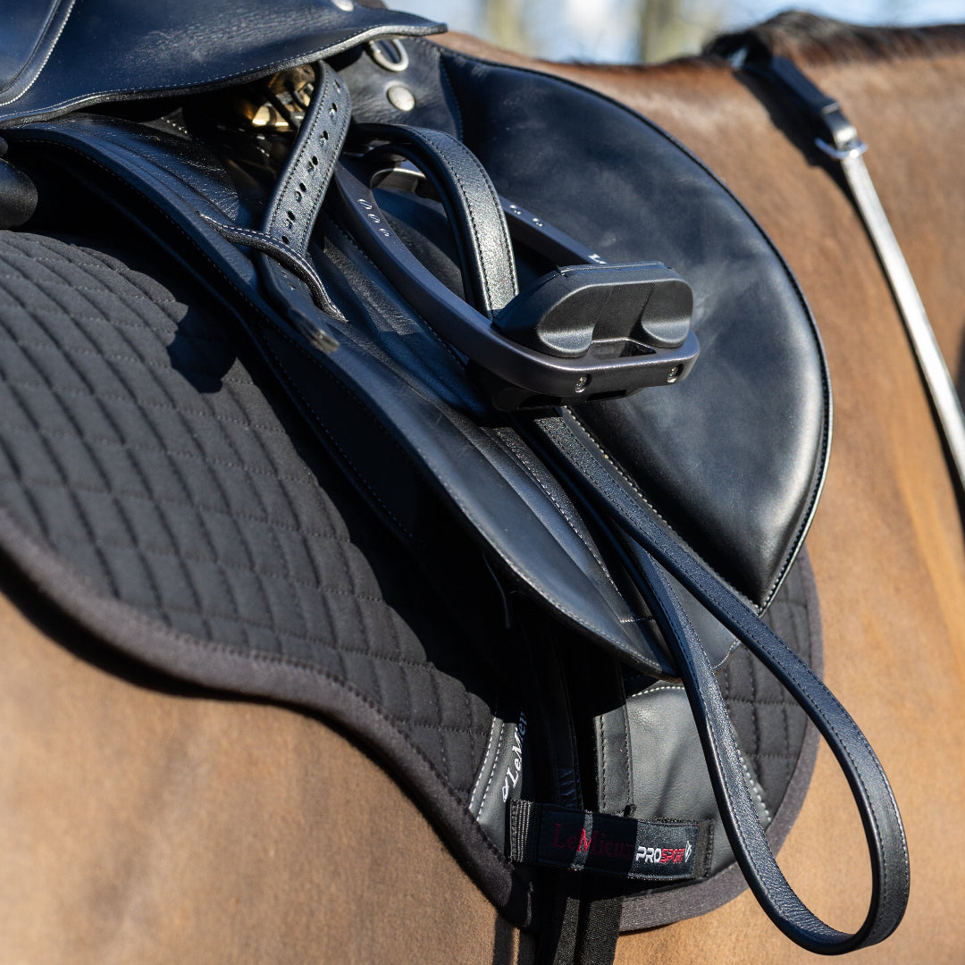 LeMieux Arika Stirrup Leathers - Black; close up shown on horse with stirrups & saddle| Tack Shop | Malvern Saddlery