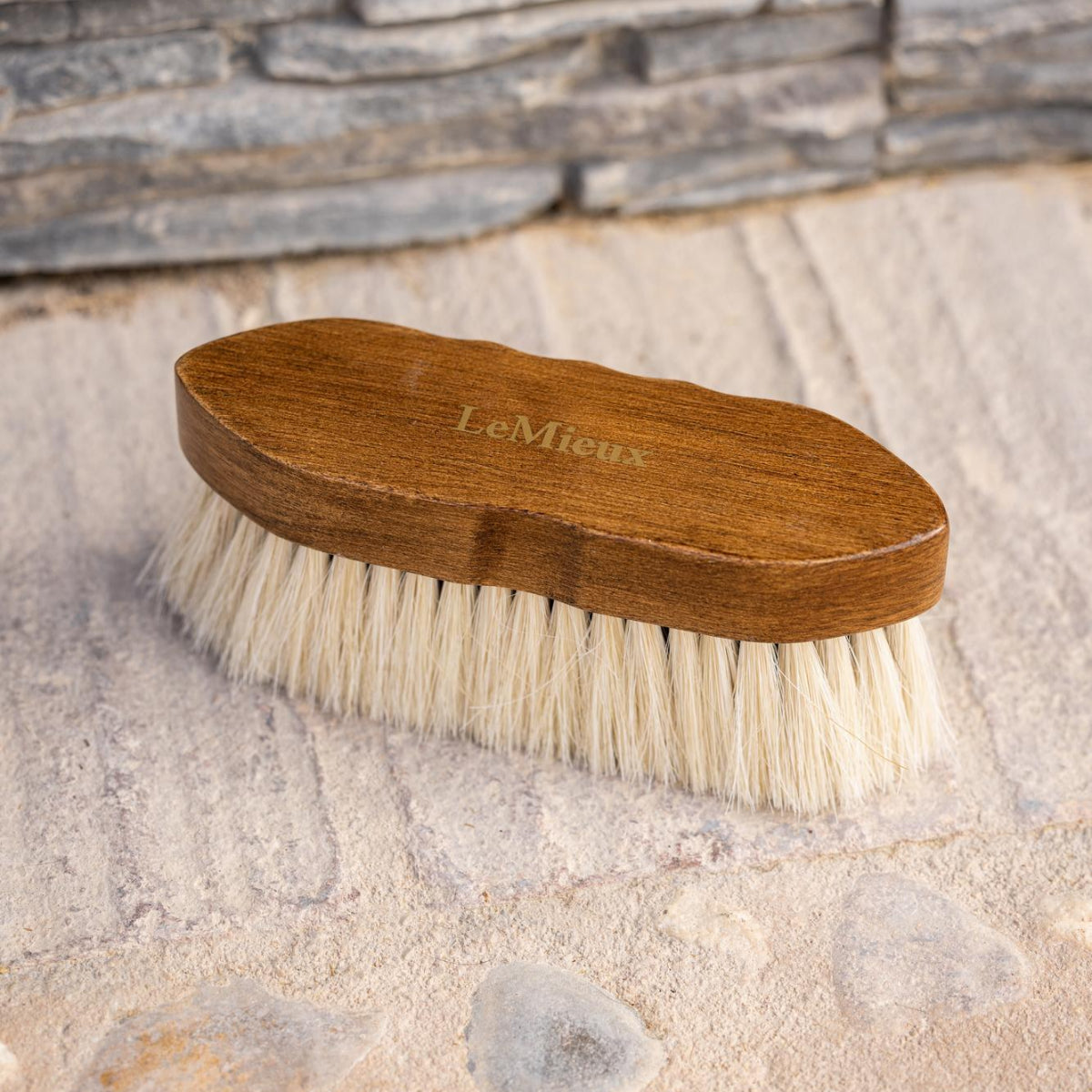 LeMieux Artisan Soft Finishing Brush - shown on cement & stone surface | Horse Grooming | Malvern Saddlery