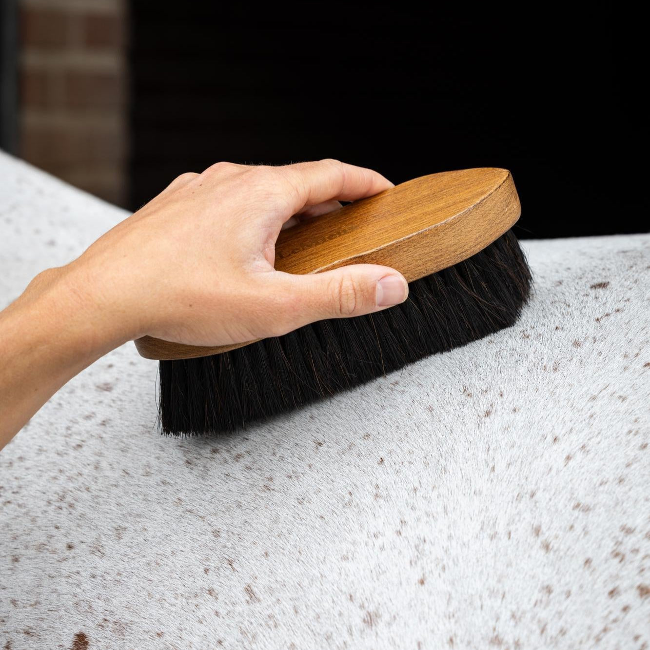 LeMieux Artisan Combi Body Brush - Brown - hand holding brush on dappled  horse | Horse Grooming | Malvern Saddlery