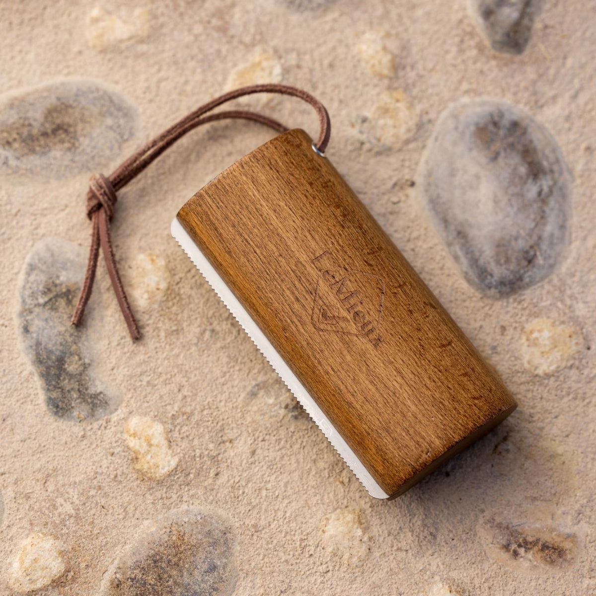 LeMieux Artisan Shedding Comb; shown on cement & stone background | Horse Grooming | Malvern Saddlery