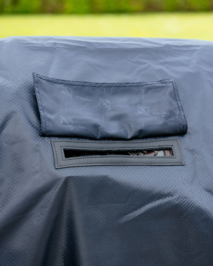 LeMieux Rain Sheet - Navy - detail of slit for stirrup leathers | Malvern Saddlery