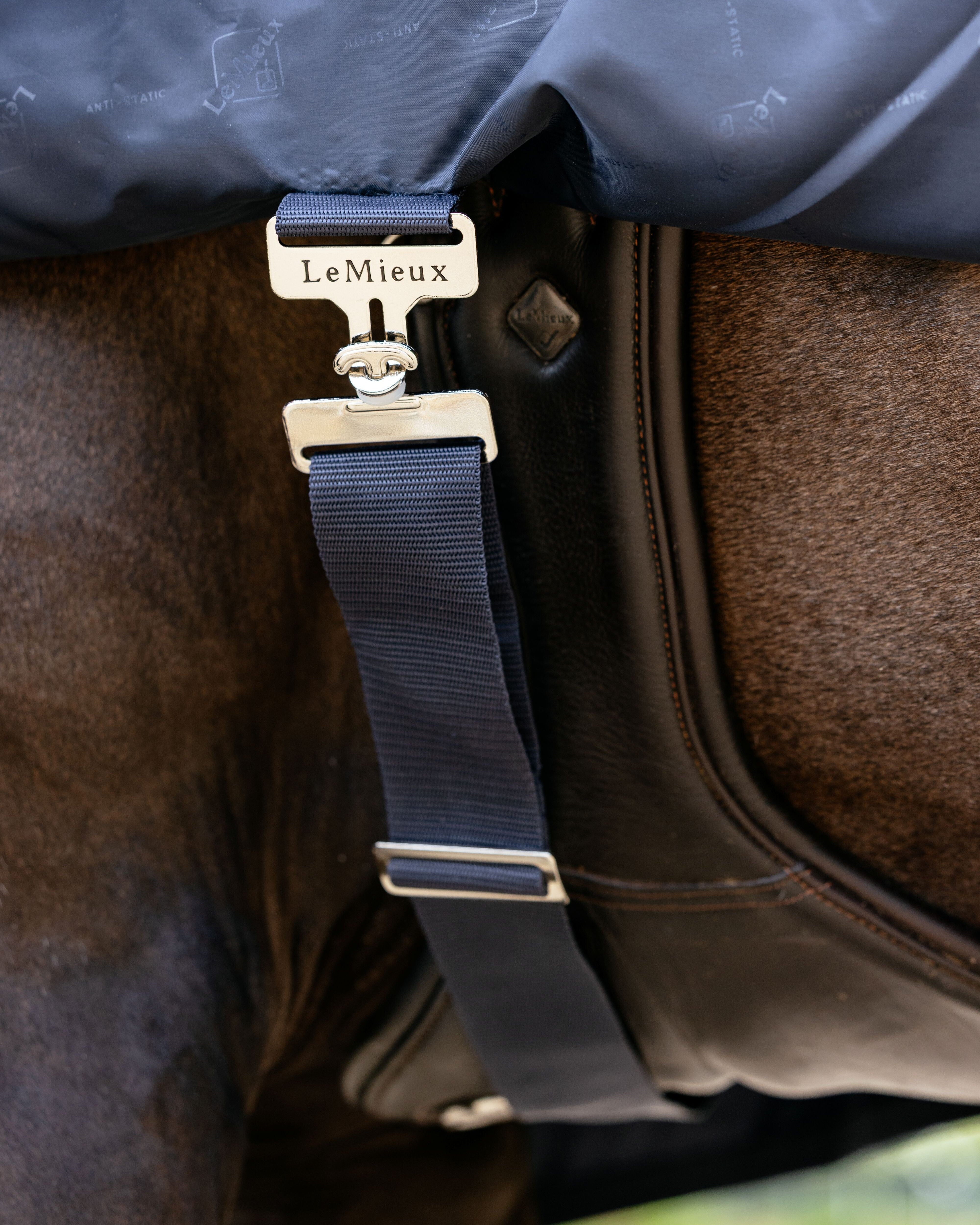LeMieux Rain Sheet - Navy - detail of strap and surcingle shown on  brown horse wearing girth | Malvern Saddlery