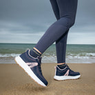 LeMieux Trax Viva Waterproof Sneaker - Navy/Pink, shown on person walking on beach | Malvern Saddlery