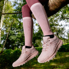 LeMieux Trax Viva Waterproof Sneaker - Blossom Pink, shown on person sitting in a tree | Malvern Saddlery