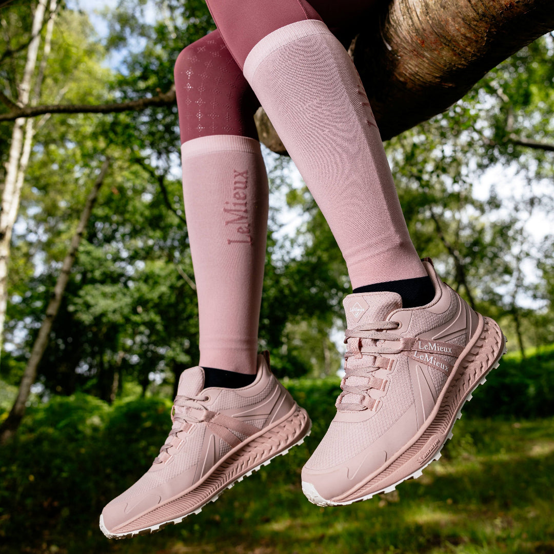 LeMieux Trax Viva Waterproof Sneaker - Blossom Pink, shown on person sitting in a tree | Malvern Saddlery