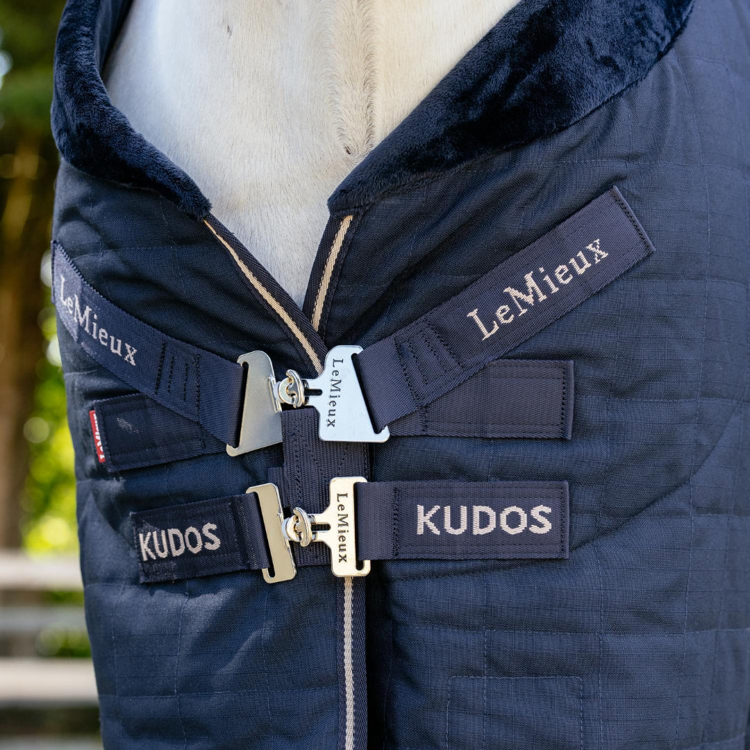LeMieux Kudos Luxe Lined Stable Rug Navy; front closures detail shown on horse outdoors | Malvern Saddlery
