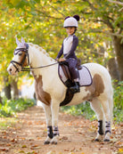 LeMieux Mini Base Layer Top - Lilac, shown on young girl on horse on bridle path | Children's Riding Apparel | Malvern Saddlery