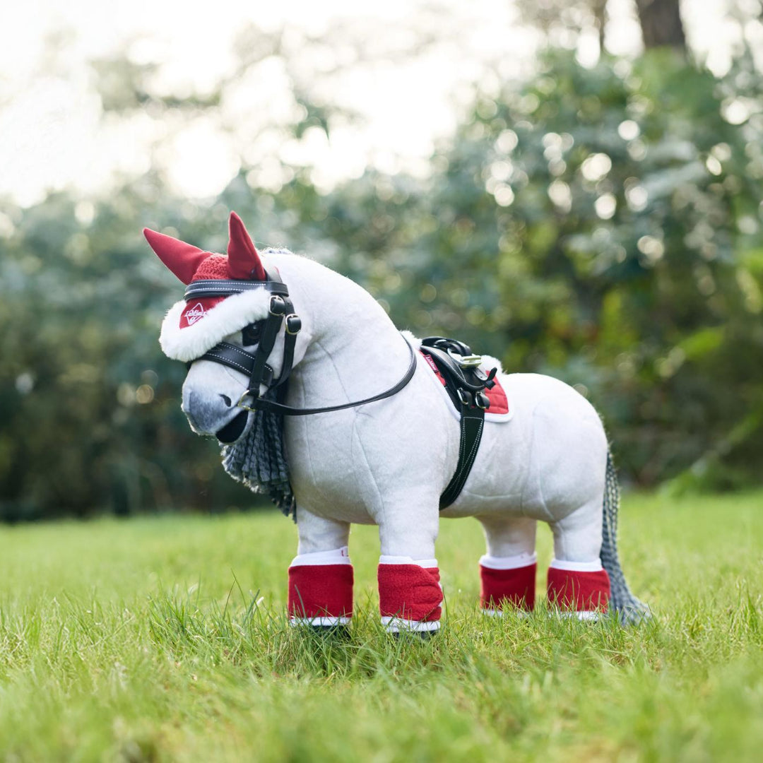 LeMieux Toy Pony Christmas Set of fly hood, saddle pad & polo wraps - red & white; shown on 'Blanca' with tack outdoors | Malvern Saddlery