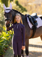 LeMieux Young Rider Mia Mesh Base Layer - Juniper Purple, shown on model standing with horse | Malvern Saddlery
