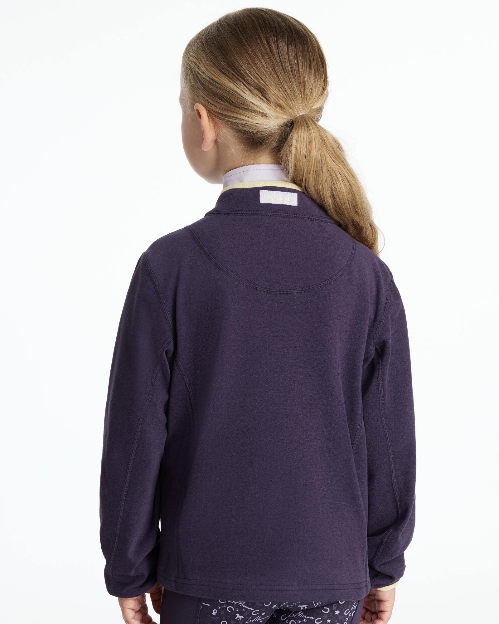 LeMieux Mini Mae Popper Fleece - Juniper Purple Pullover - back view, shown on young girl on white background | Children's Activewear | Malvern Saddlery