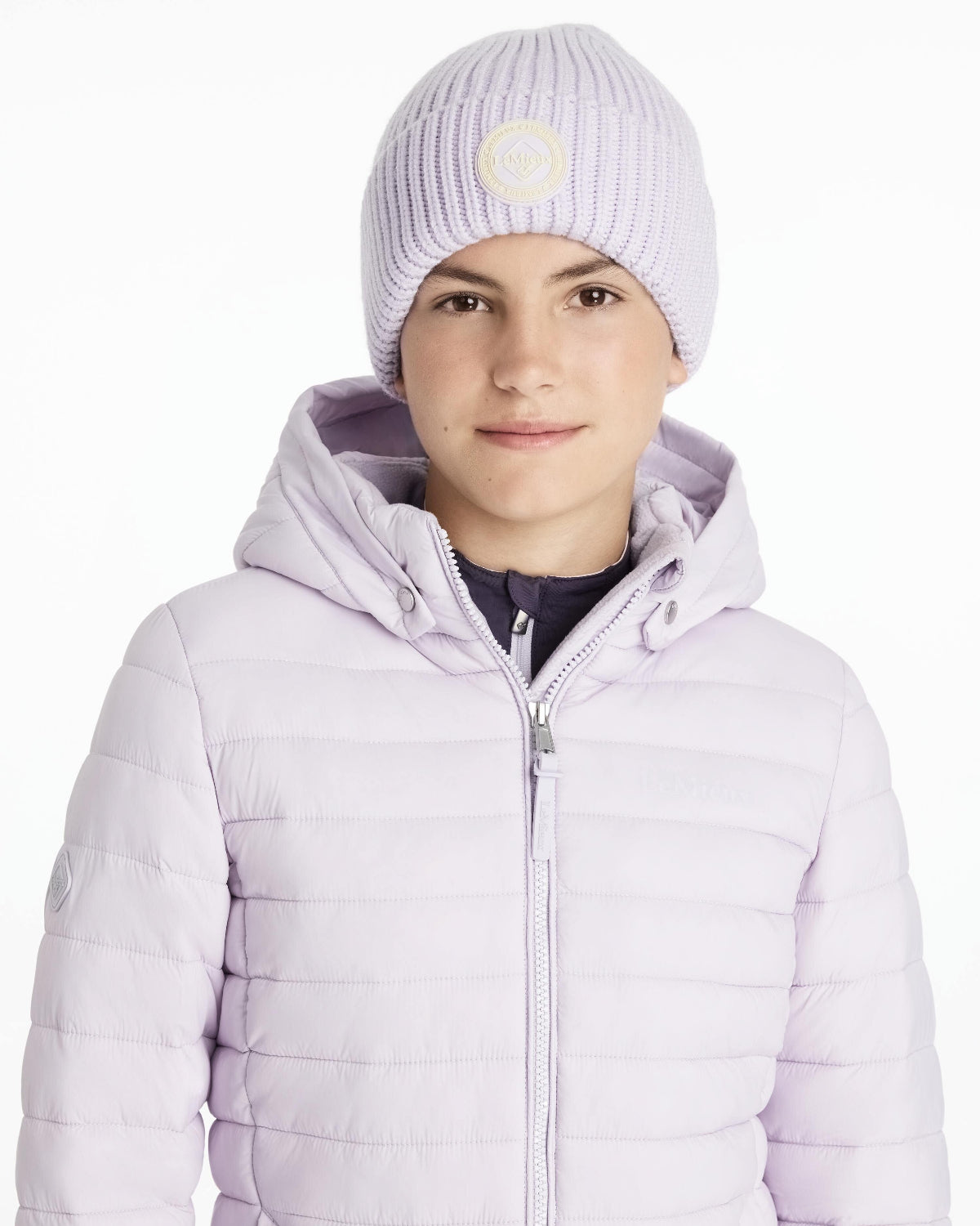 LeMieux Bodie Beanie - Lilac, shown on person wearing light purple coat on white background | Winter Hats | Malvern Saddlery