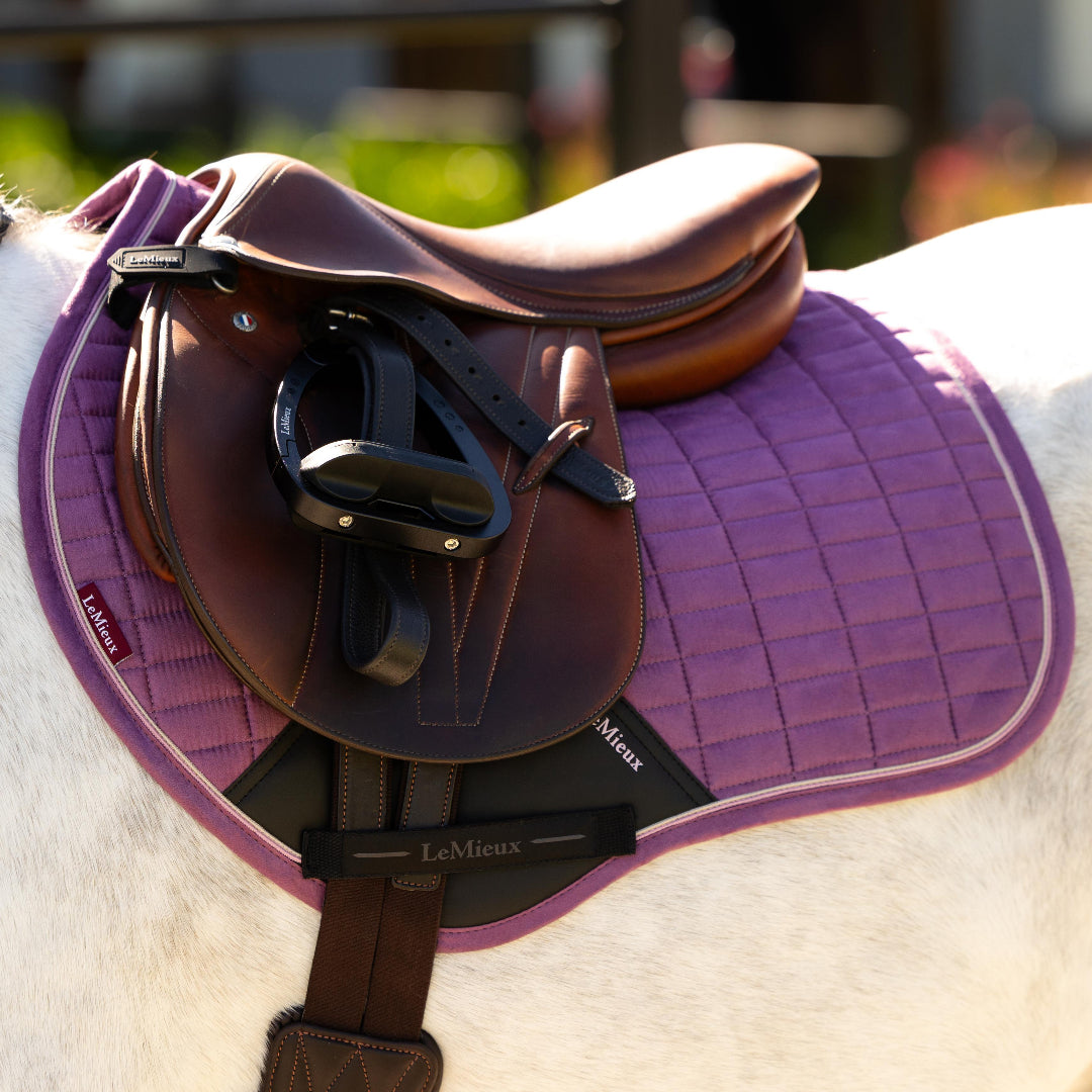 LeMieux Mini Suede Close Contact Square Saddle Pad - Mallow; close up shown on white horse with brown saddle | Malvern Saddlery