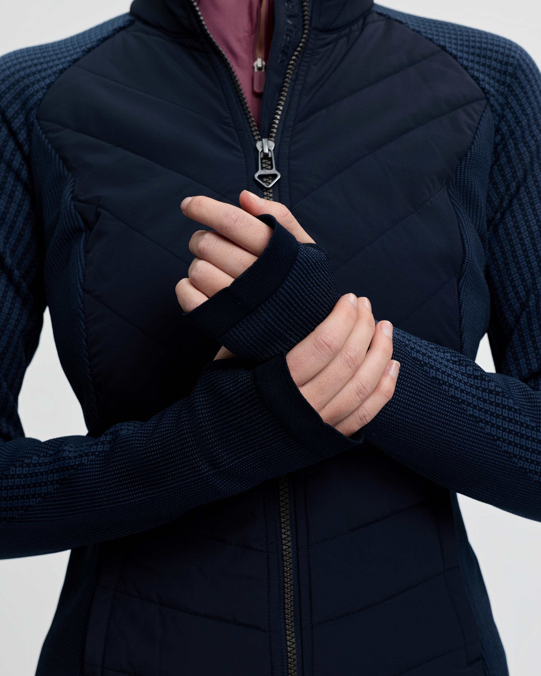 LeMieux Women's Maddie Hybrid Jacket - Navy; shown on person, close up hands in thumbholes | Riding Apparel | Malvern Saddlery
