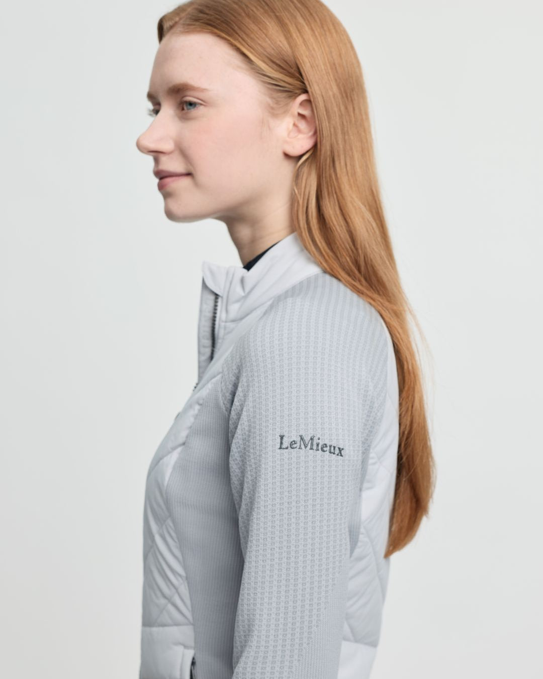 LeMieux Women's Maddie Hybrid Jacket - Light Gray; shown on person, left side | Riding Apparel | Malvern Saddlery