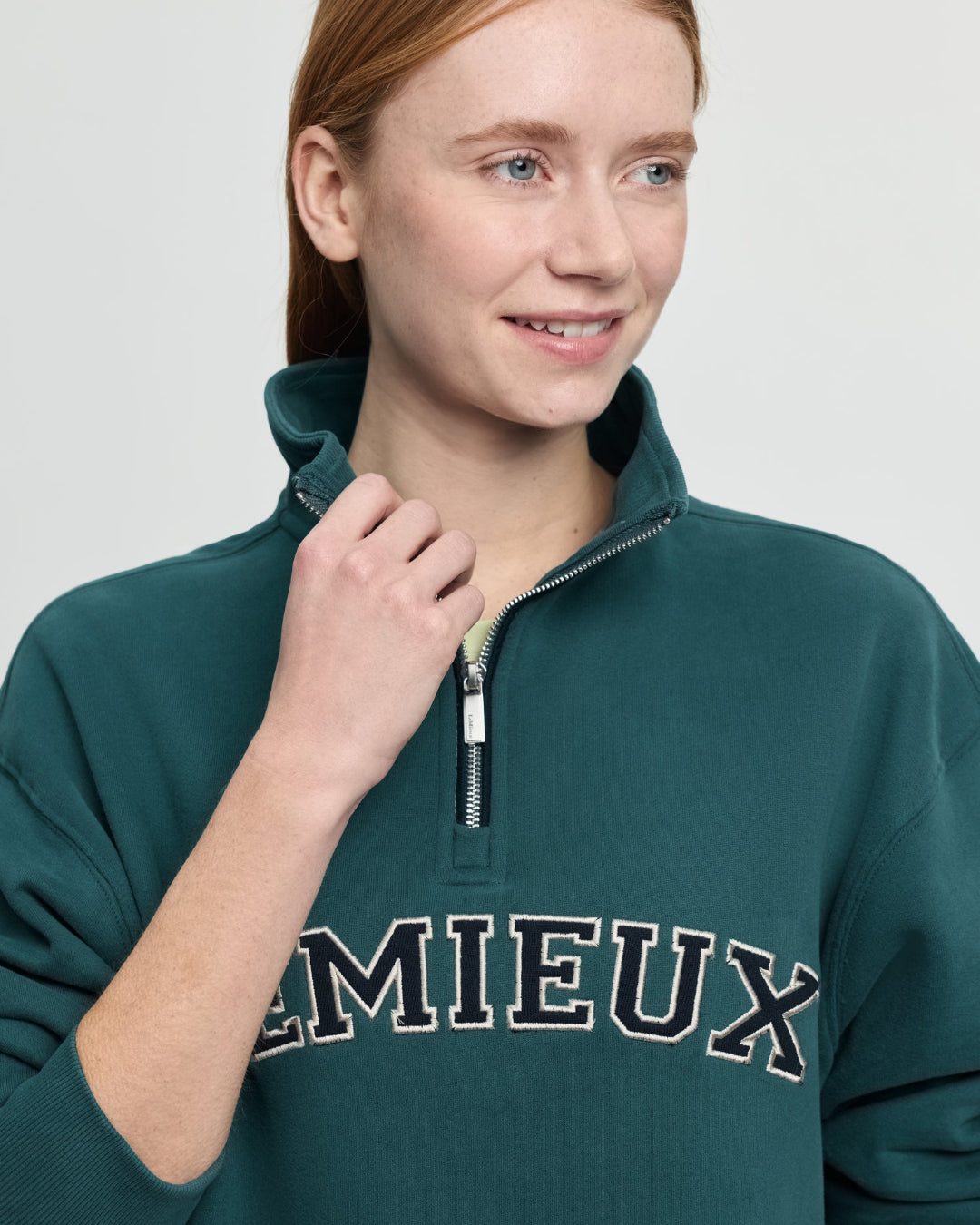 LeMieux Kelsie Quarter Neck Sweatshirt - Jungle Green; close up shown on person against gray background | Malvern Saddlery
